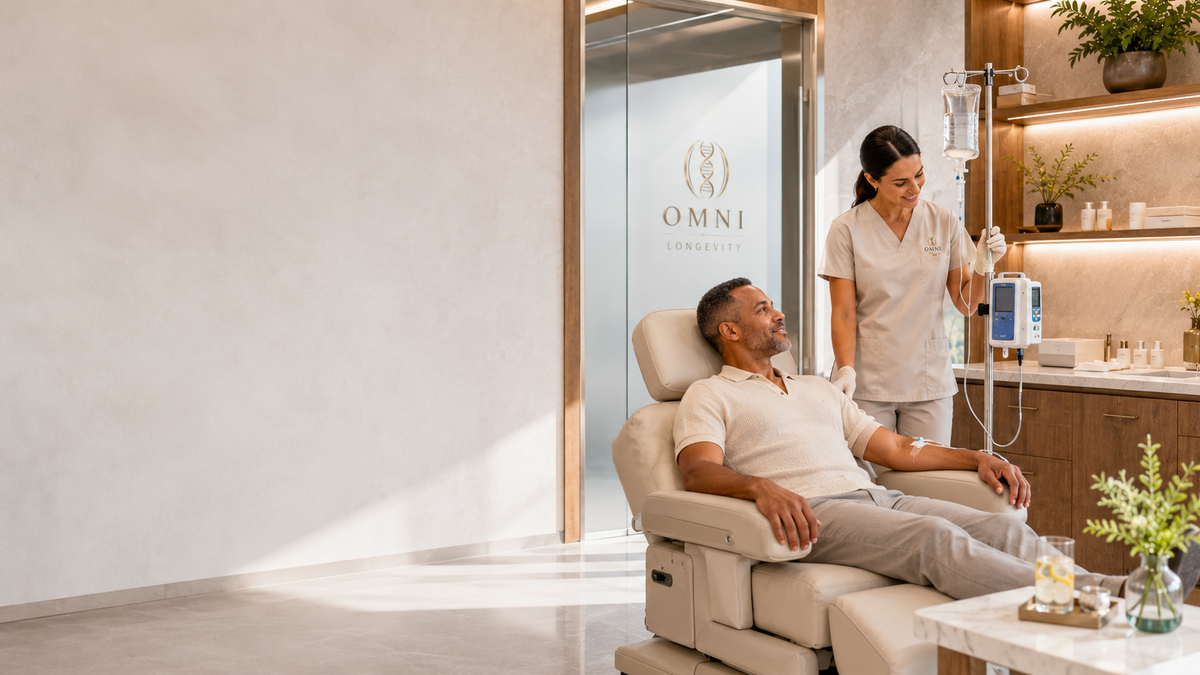 A guest receives an IV infusion with an Omni care provider in a treatment room.